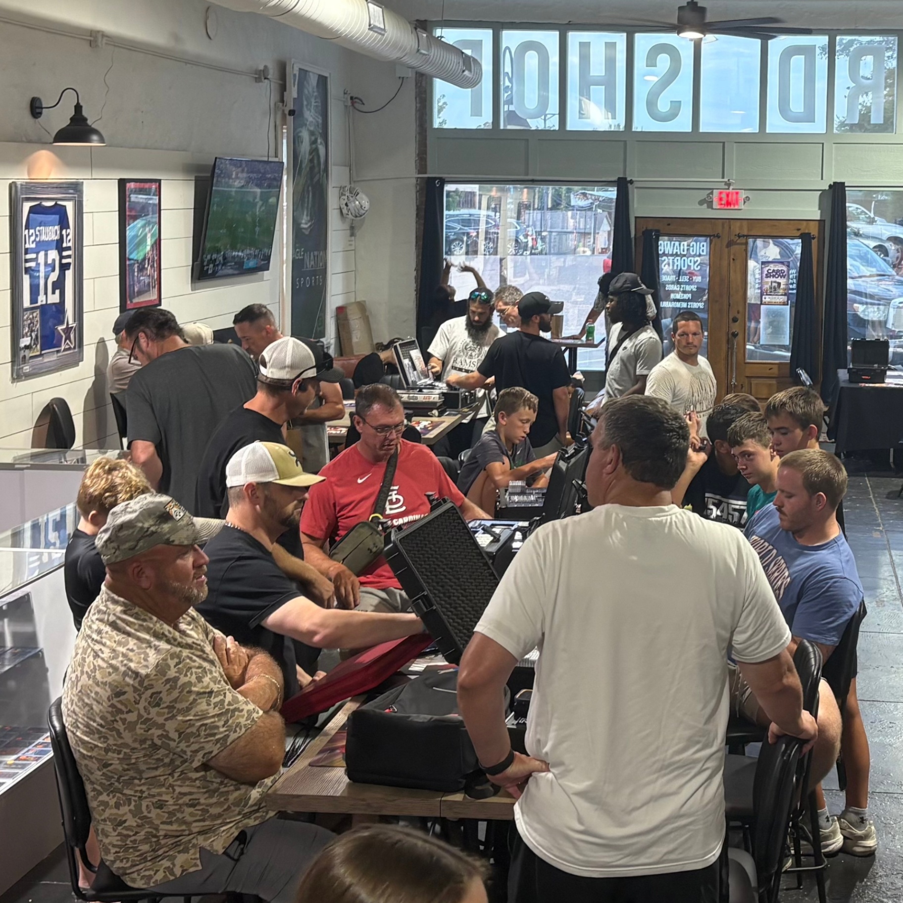 Collectors trading around the tables at Big Dawg Sports