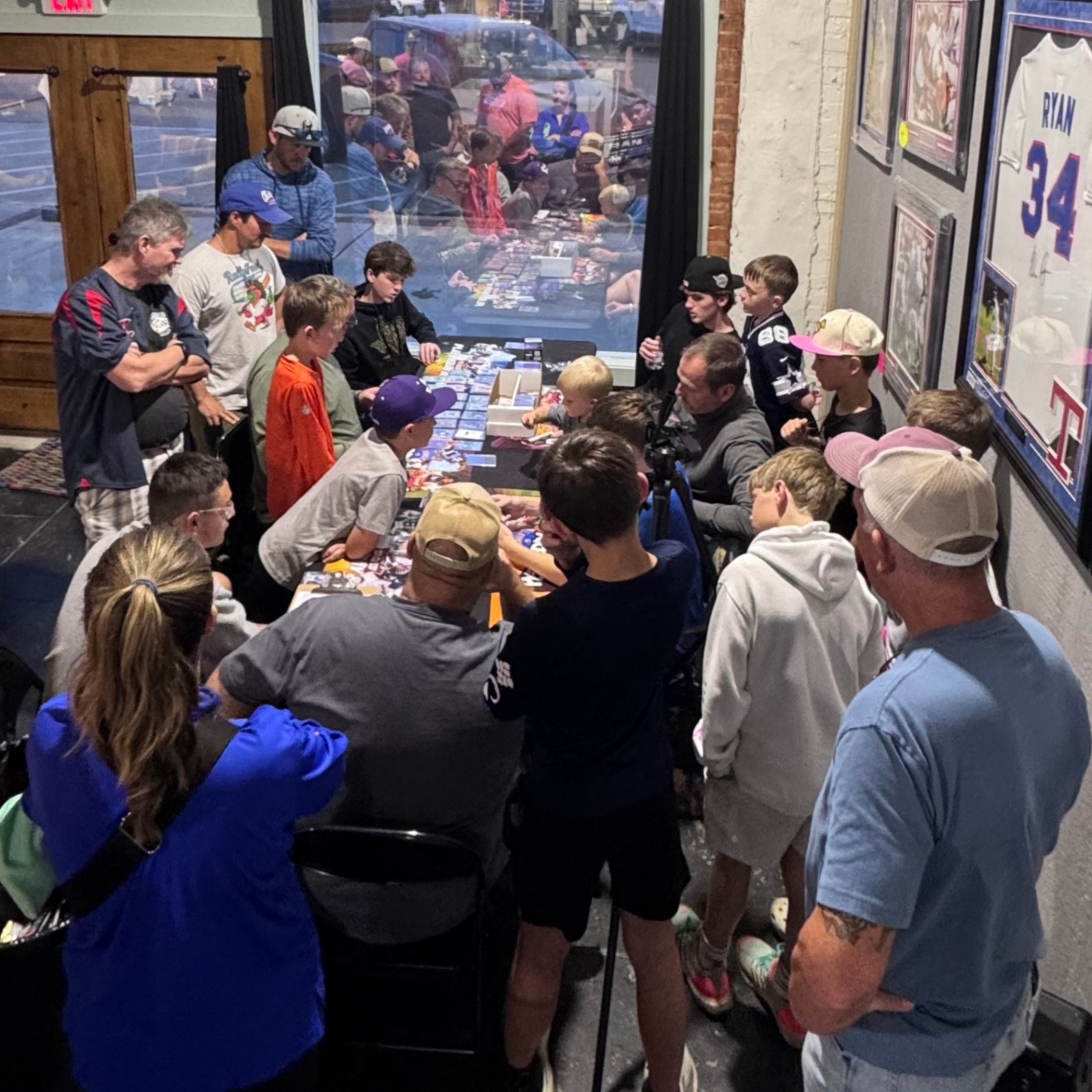 Trade night crowd sorting cards along the front window