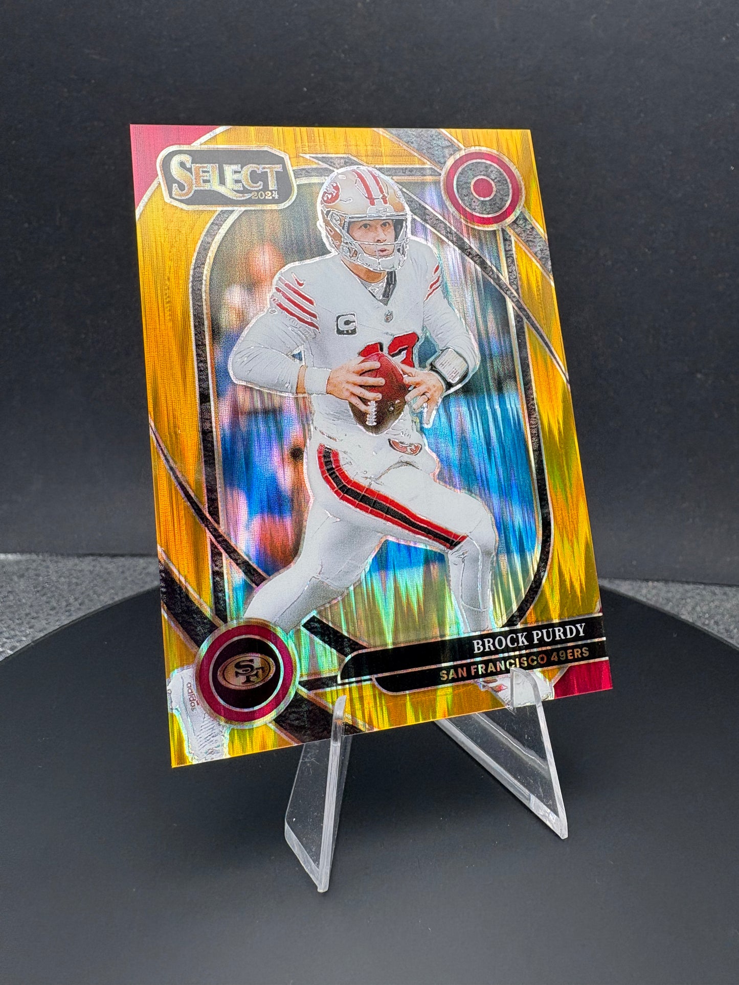 2024 Select Brock Purdy Shock Prizm /10 red and yellow